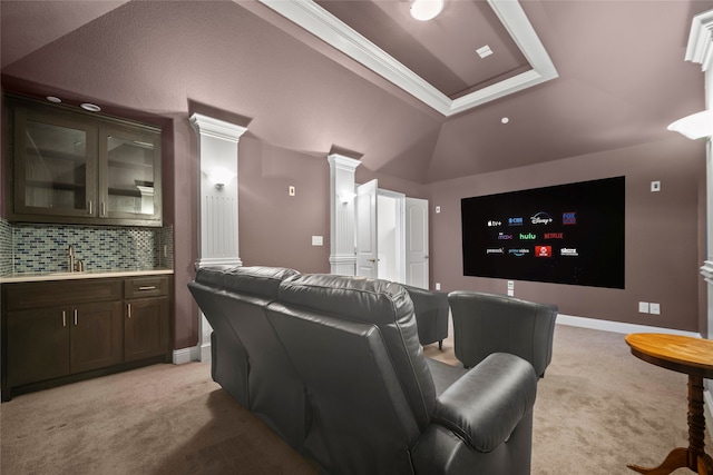 home theater room featuring lofted ceiling, sink, light colored carpet, and decorative columns