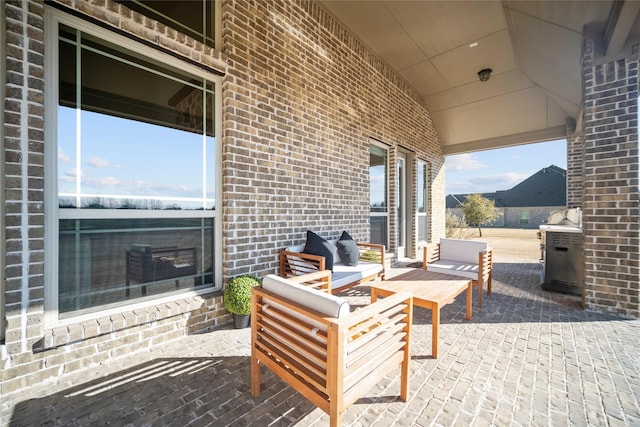 view of patio / terrace with outdoor lounge area, an outdoor kitchen, and a mountain view