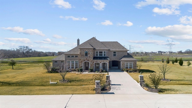 french provincial home with a front lawn