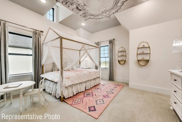 bedroom with recessed lighting, light colored carpet, and baseboards