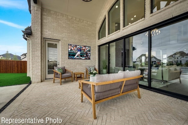 view of patio with outdoor lounge area and fence