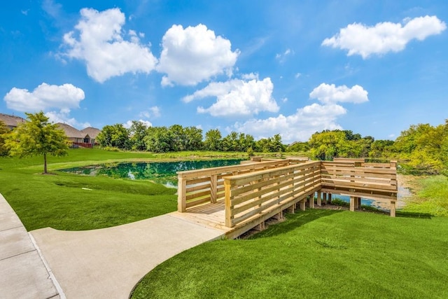 view of community featuring a lawn and a water view