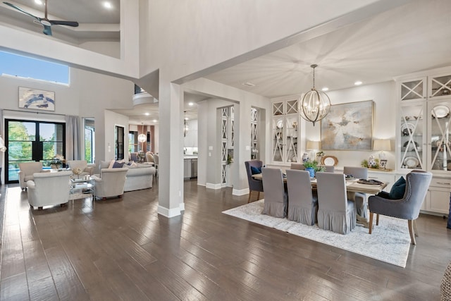 dining space featuring a notable chandelier and dark wood-type flooring