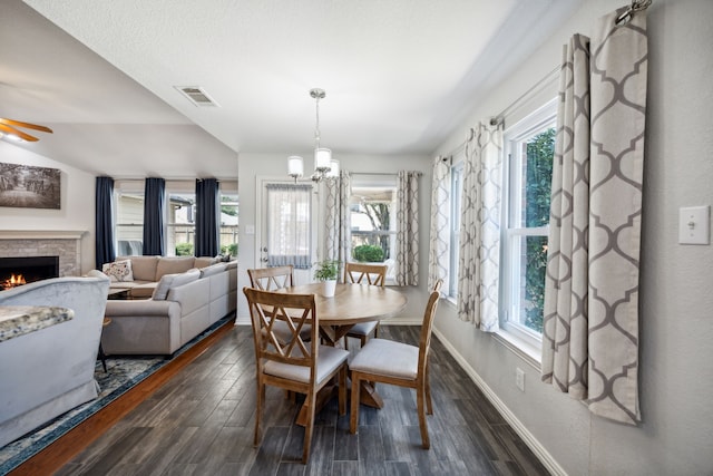 dining area with a healthy amount of sunlight, dark wood-type flooring, and ceiling fan