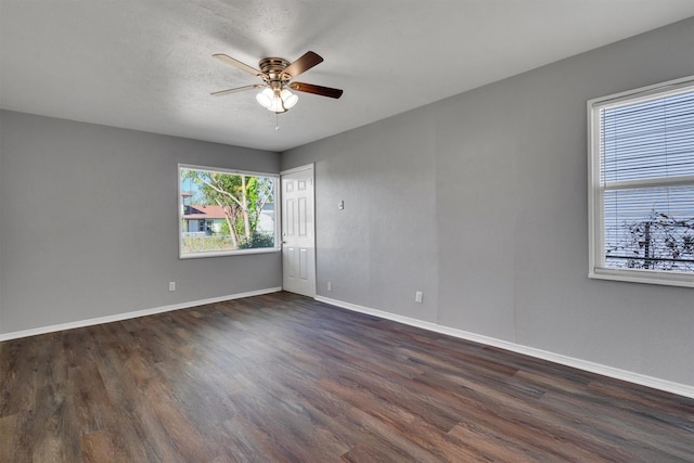 empty room featuring dark hardwood / wood-style floors, a textured ceiling, and ceiling fan