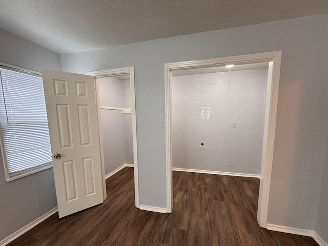 interior space with dark hardwood / wood-style floors and a closet