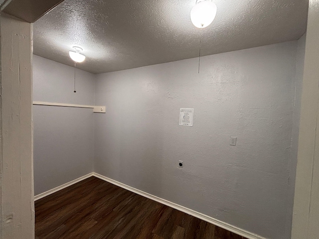 spare room with dark wood-type flooring and a textured ceiling