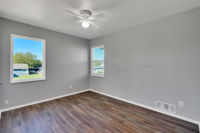 spare room with dark hardwood / wood-style floors and ceiling fan