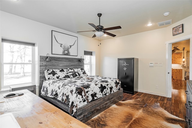 bedroom with ceiling fan and dark hardwood / wood-style flooring