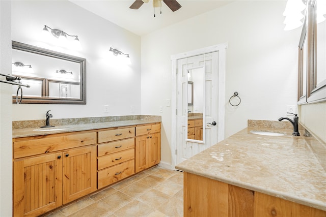 bathroom with tile patterned flooring, vanity, and ceiling fan