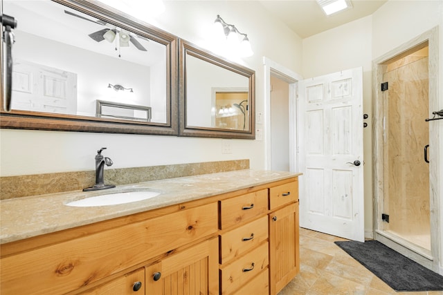 bathroom featuring ceiling fan, vanity, and an enclosed shower