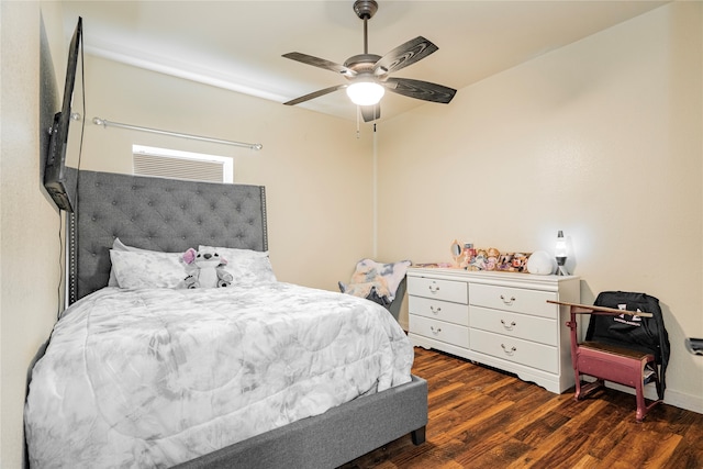 bedroom with dark hardwood / wood-style flooring and ceiling fan