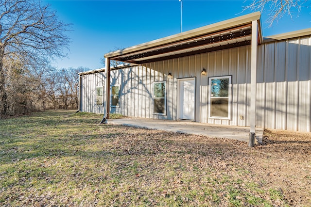 back of property with a patio and a lawn