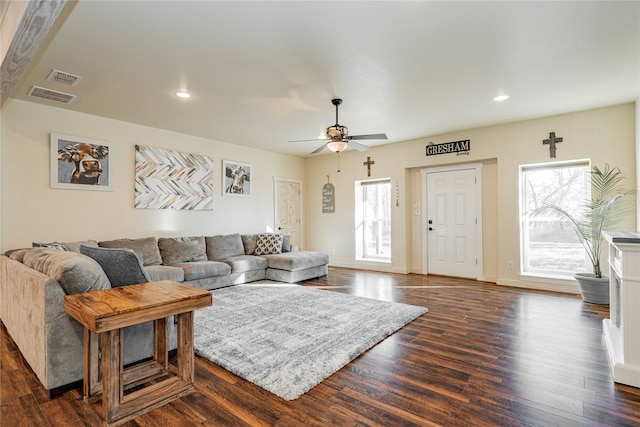 living room with ceiling fan and dark hardwood / wood-style flooring