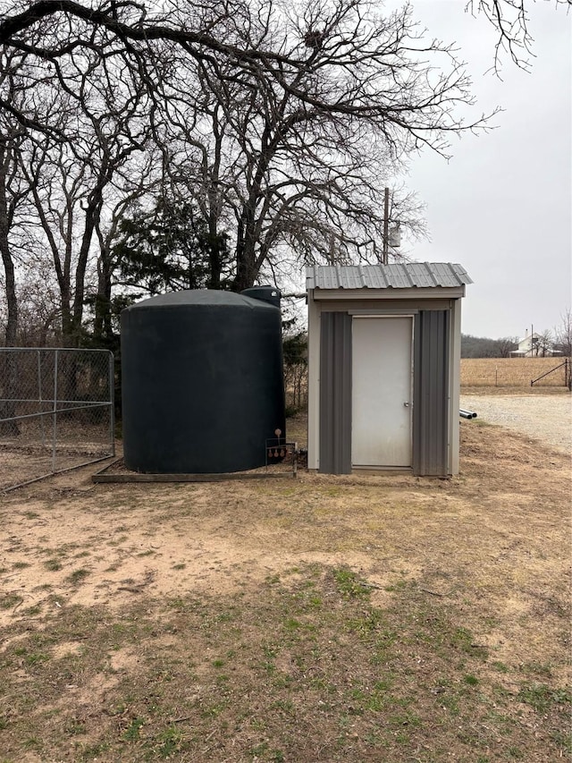 view of shed featuring fence