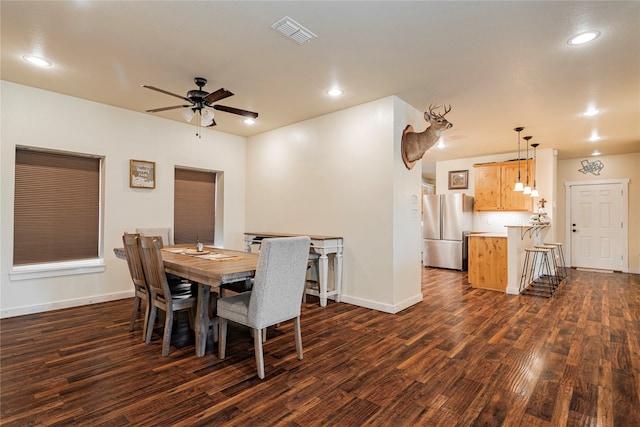 dining room with ceiling fan and dark hardwood / wood-style flooring