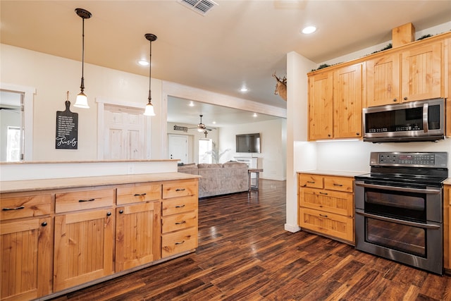 kitchen featuring light brown cabinetry, hanging light fixtures, dark hardwood / wood-style flooring, ceiling fan, and stainless steel appliances