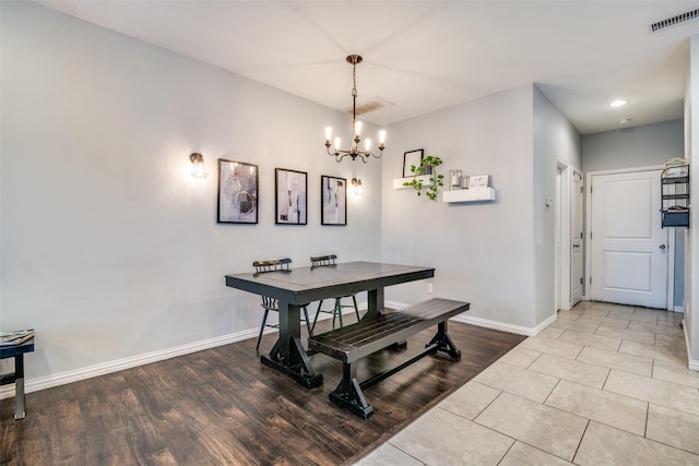 dining area featuring a notable chandelier and light hardwood / wood-style floors