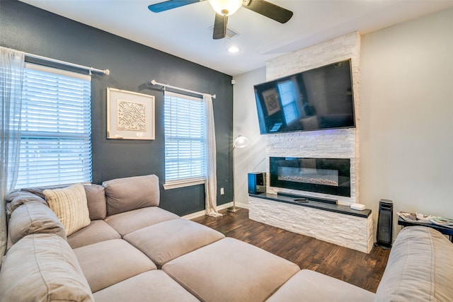 living room with ceiling fan, a fireplace, and dark hardwood / wood-style flooring