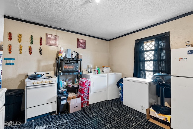 laundry room with separate washer and dryer and a textured ceiling