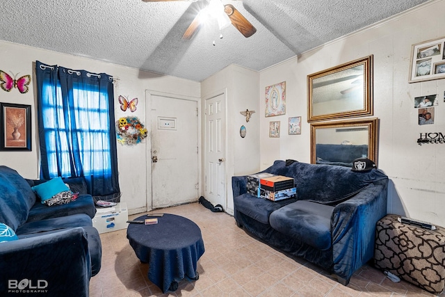 living room featuring ceiling fan and a textured ceiling