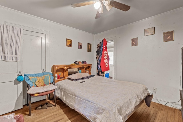 bedroom with crown molding and wood-type flooring