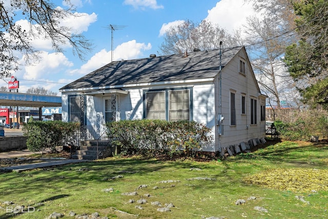 bungalow-style home featuring a front yard