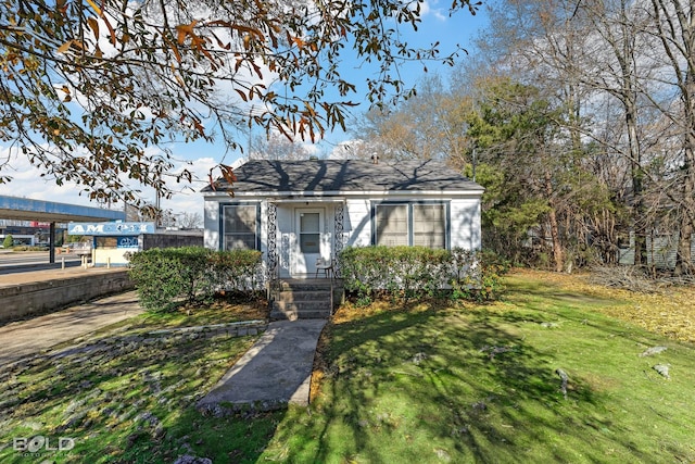 bungalow-style home featuring a front lawn