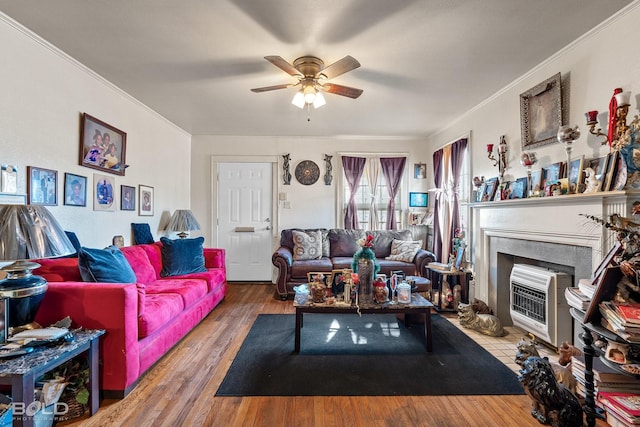 living room with hardwood / wood-style floors, ornamental molding, and ceiling fan