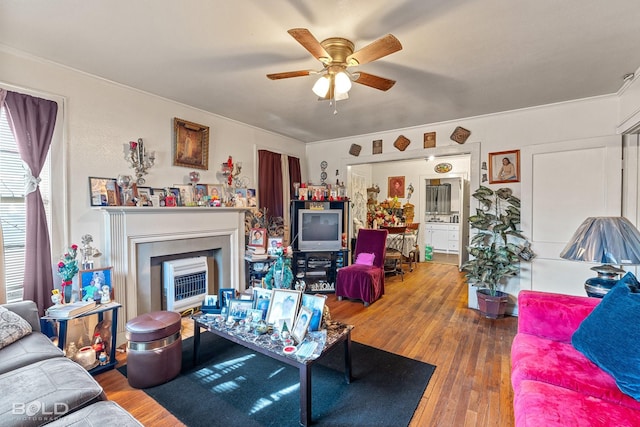 living room featuring wood-type flooring and ceiling fan