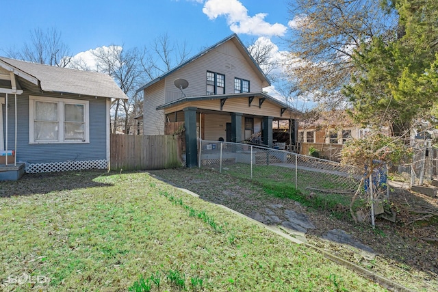 rear view of property featuring a yard