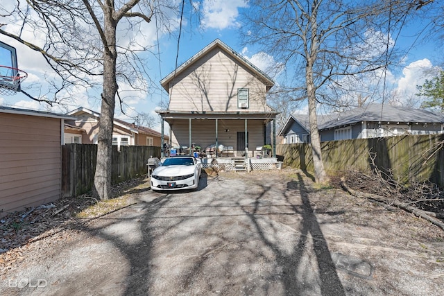 back of property with covered porch