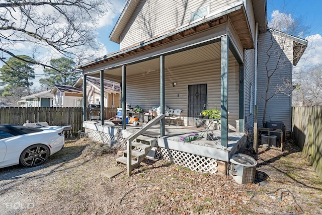 back of house featuring a porch