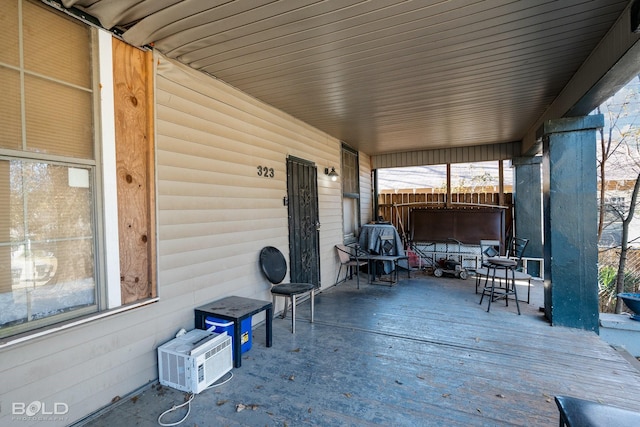 view of patio with an AC wall unit