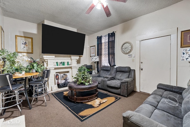 carpeted living room with ceiling fan, a fireplace, and a textured ceiling