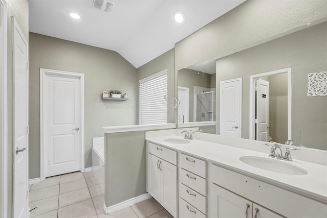 bathroom with double vanity, tile patterned flooring, a sink, and a shower stall