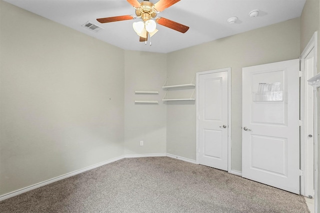 unfurnished bedroom featuring a ceiling fan, carpet, visible vents, and baseboards