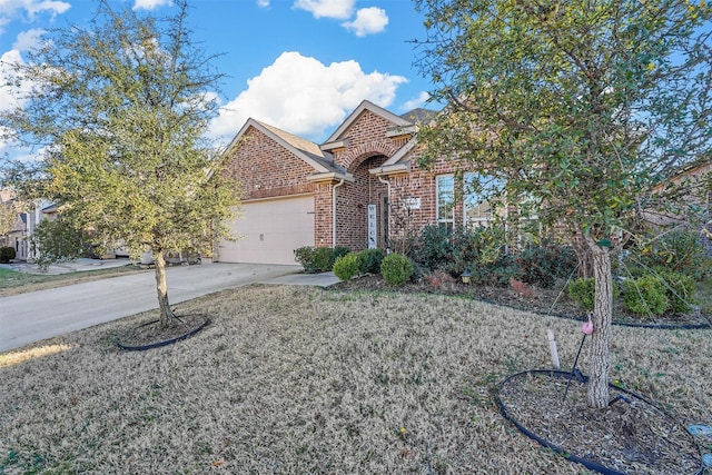 view of front facade with driveway, an attached garage, a front lawn, and brick siding