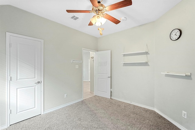 unfurnished bedroom featuring a ceiling fan, baseboards, visible vents, and carpet flooring