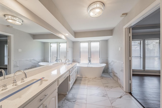 bathroom featuring vanity, tile walls, and a bathtub