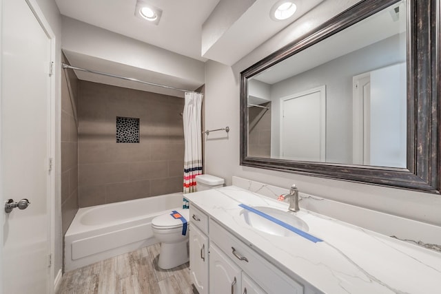 full bathroom featuring vanity, wood-type flooring, toilet, and shower / tub combo with curtain