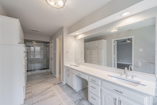 bathroom with vanity, a shower with shower door, and ceiling fan