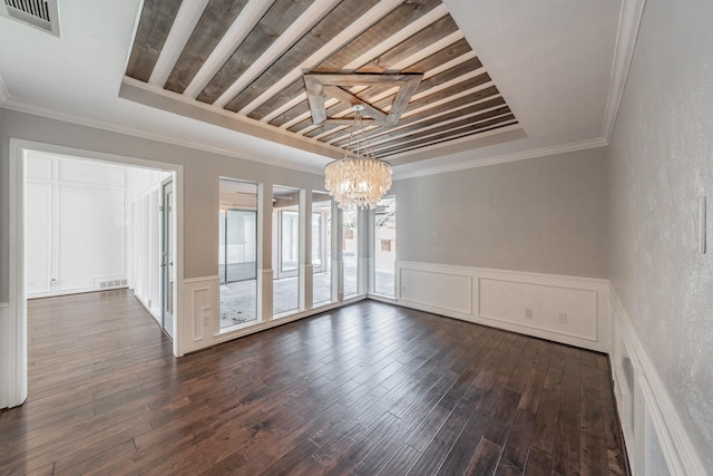 spare room with ornamental molding, dark hardwood / wood-style floors, and a notable chandelier