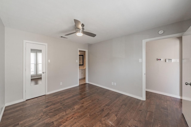 unfurnished room featuring dark wood-type flooring and ceiling fan