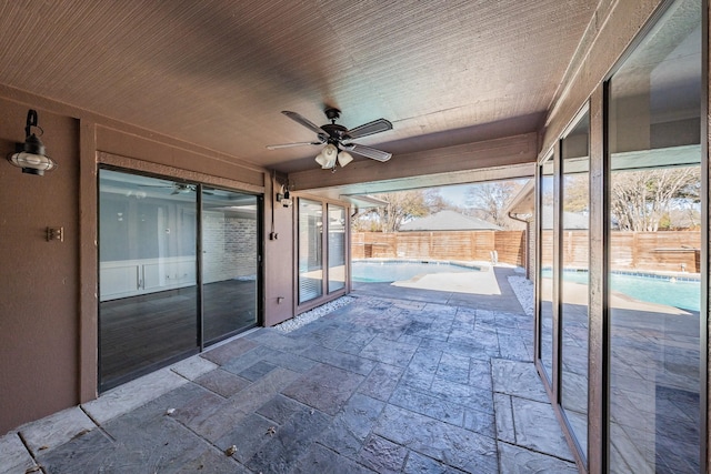 view of patio / terrace with ceiling fan and a fenced in pool