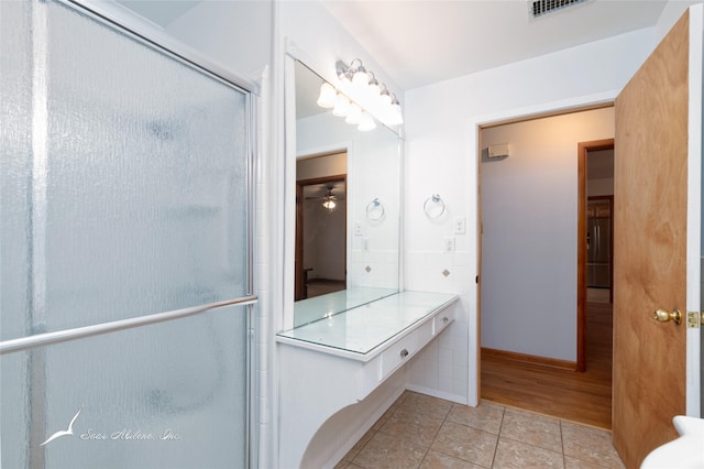 bathroom featuring a shower with door and tile patterned floors