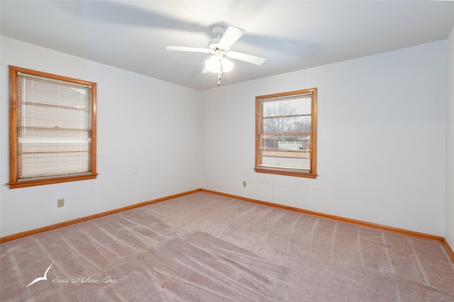 spare room with carpet flooring and ceiling fan