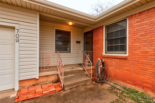 view of exterior entry featuring a garage