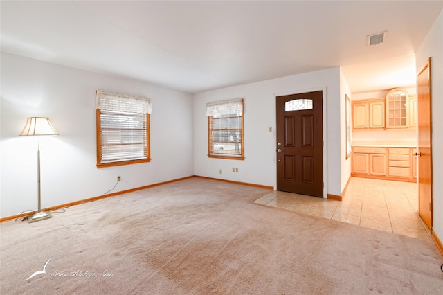 entrance foyer featuring light colored carpet