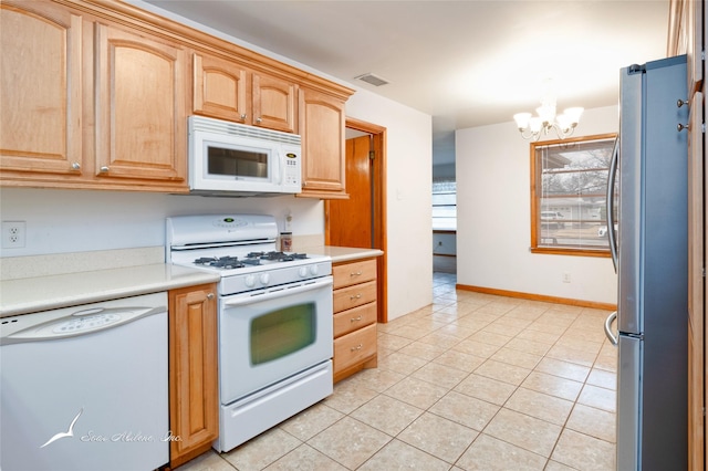 kitchen with decorative light fixtures, a chandelier, light tile patterned floors, light brown cabinets, and white appliances